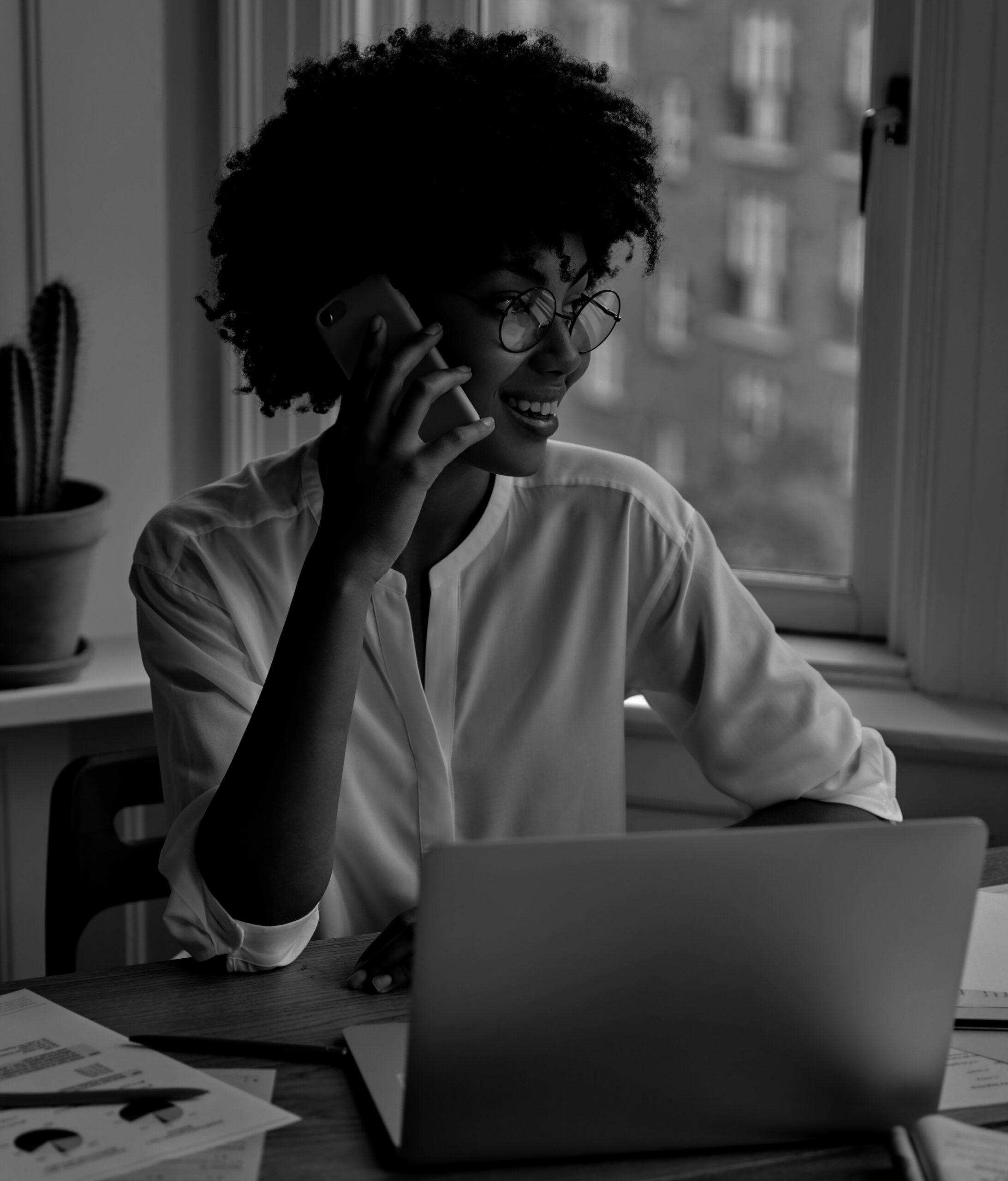 vertical-shot-pretty-black-businesswoman-examines-charts-papers-1